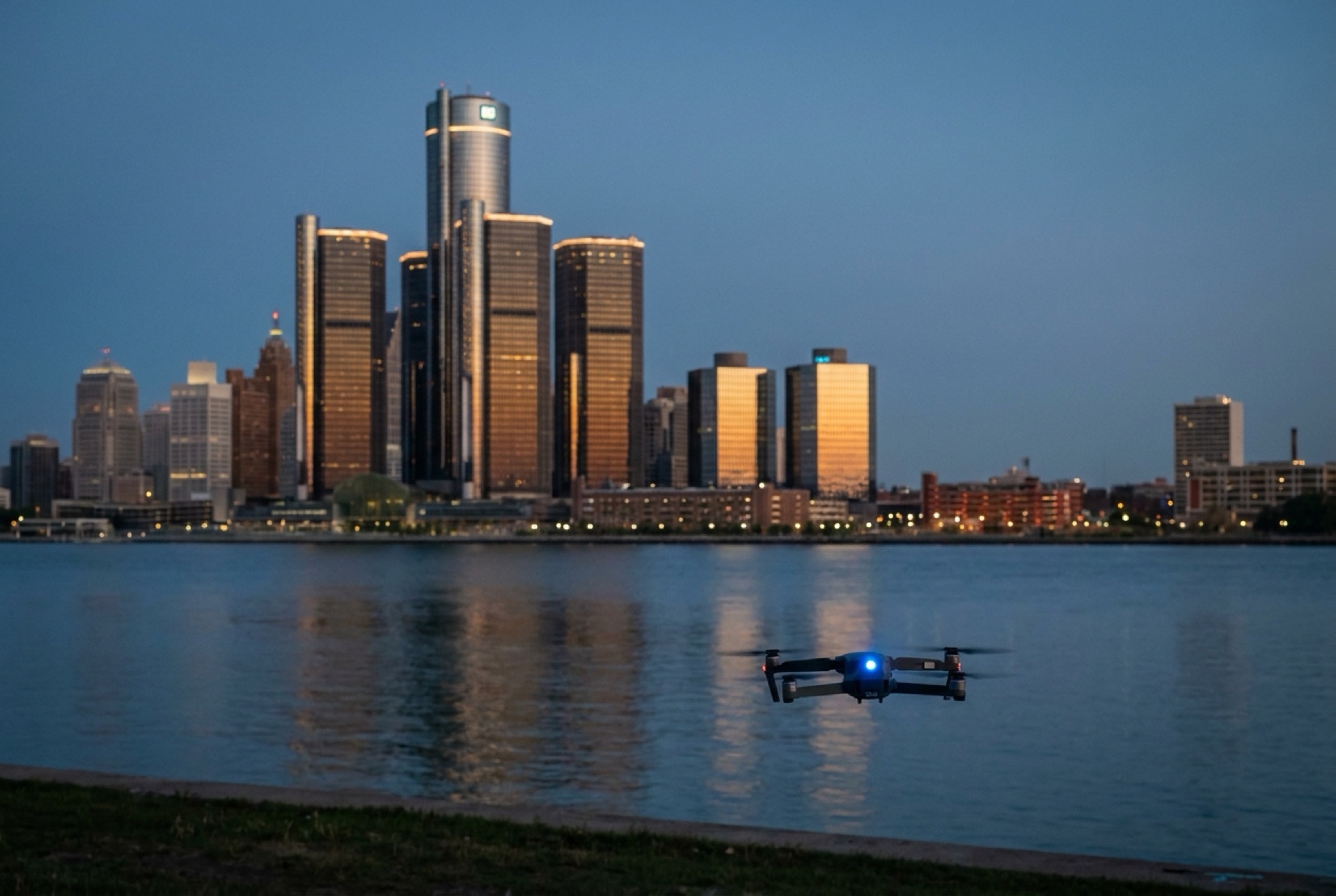 A city skyline at dusk with a drone over the river